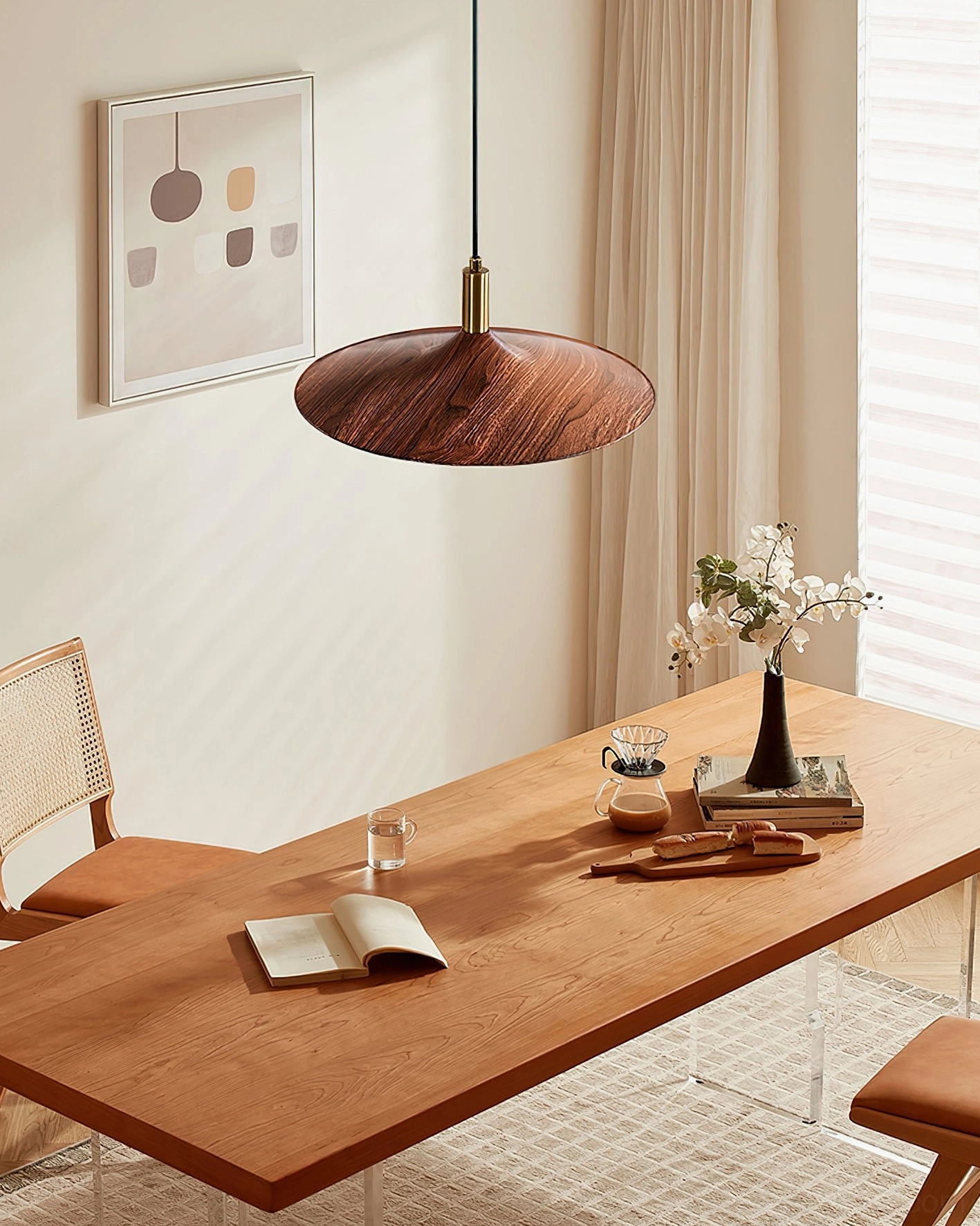 Nano pendant light suspended above wooden dining table in cozy dining room setting