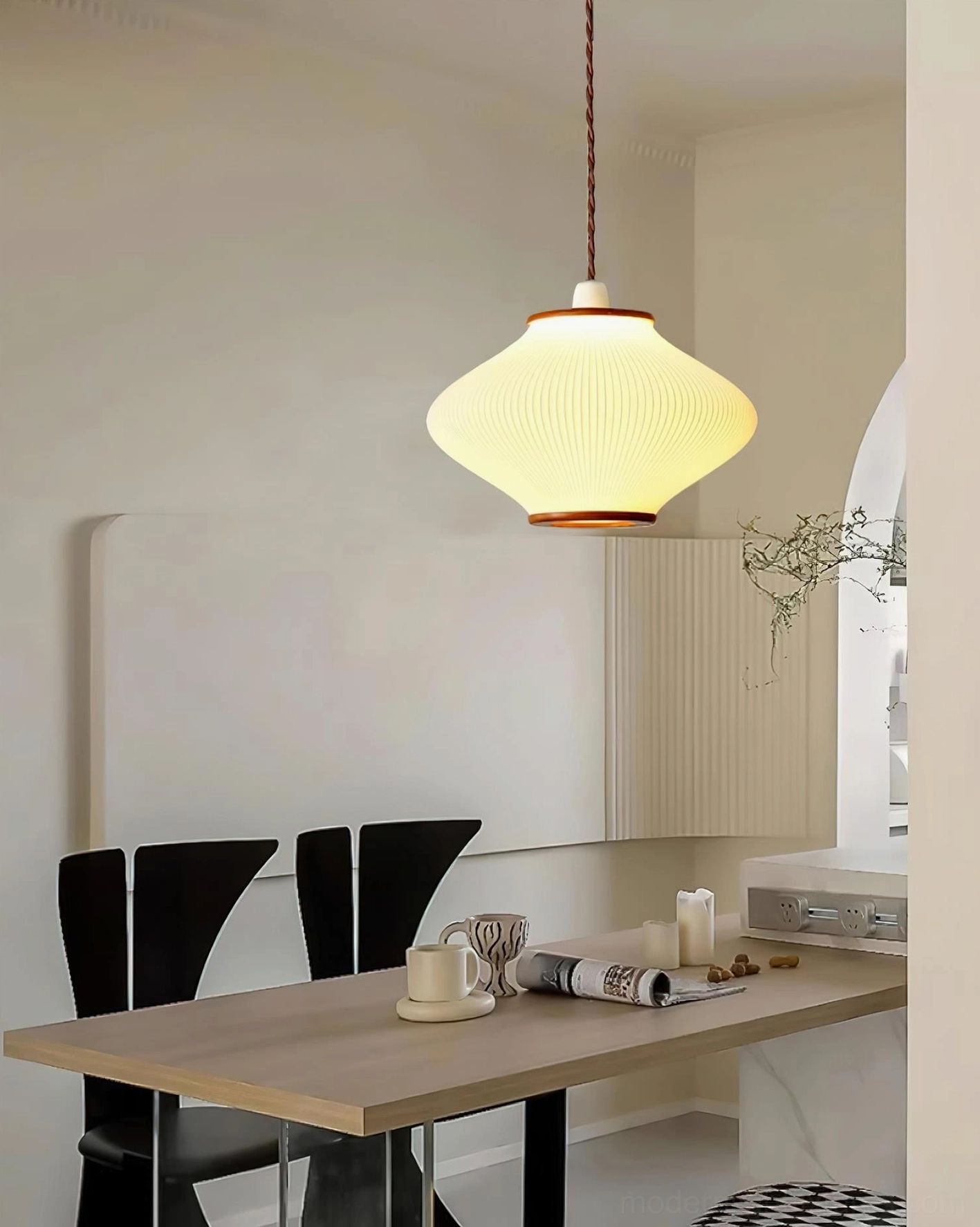 Ribbed acrylic pendant light creating focused illumination over dining surface, functional design view