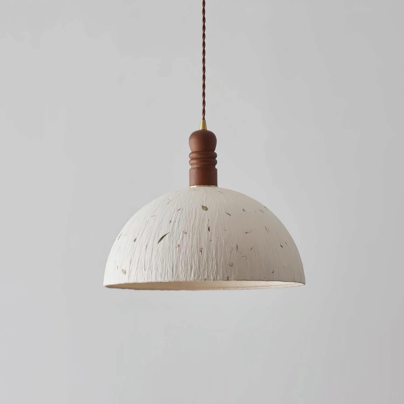 Rice paper dome pendant light illuminated, showing warm diffused glow and shadow patterns created