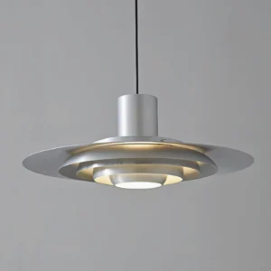 Close-up front view of layered aluminum disc shade pendant light with warm illumination, sleek metal construction detail