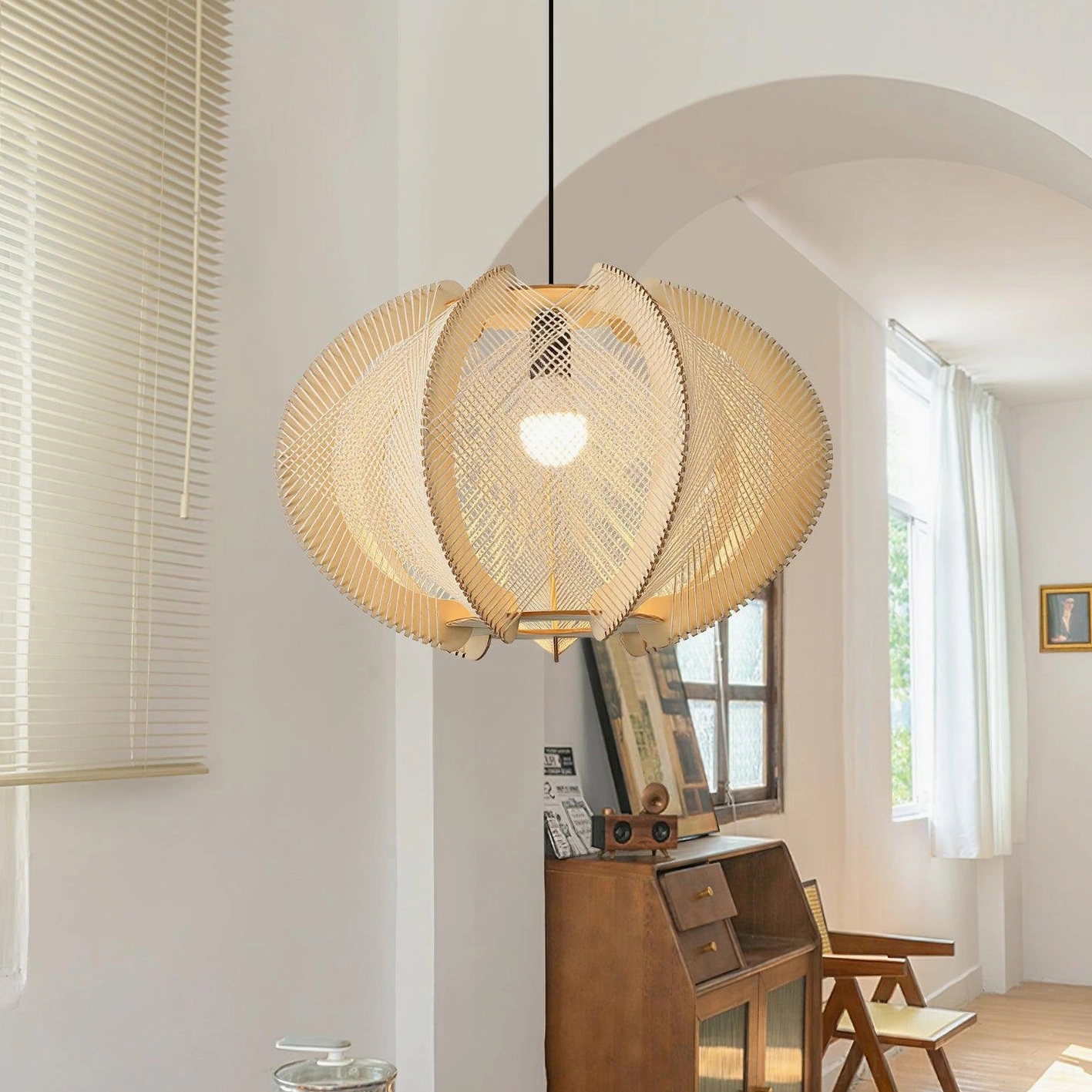 Illuminated wood pendant light in home study nook with arched window and retro interior