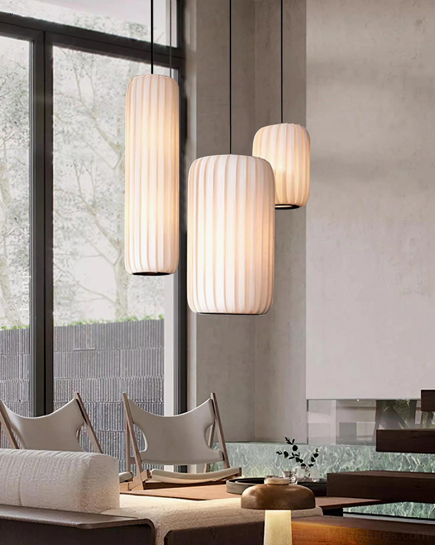 Modern white pendant light suspended from adjustable cord showing full fixture profile