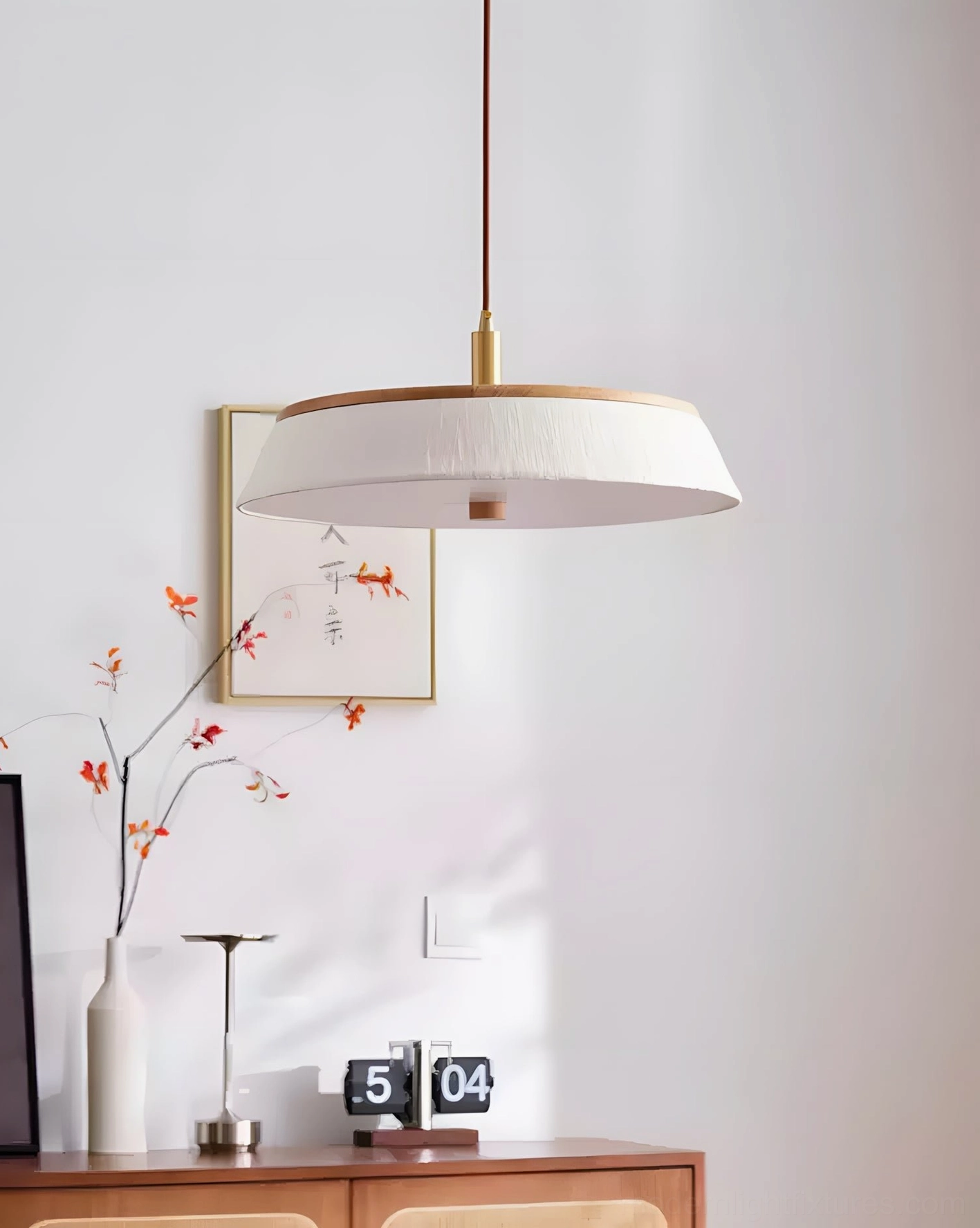 Walnette pendant light detail showing solid wood rim, turned-wood knob, and brass-tone socket with adjustable cord