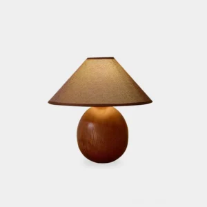 Penna walnut wooden table lamp with conical fabric shade, front view on white studio backdrop