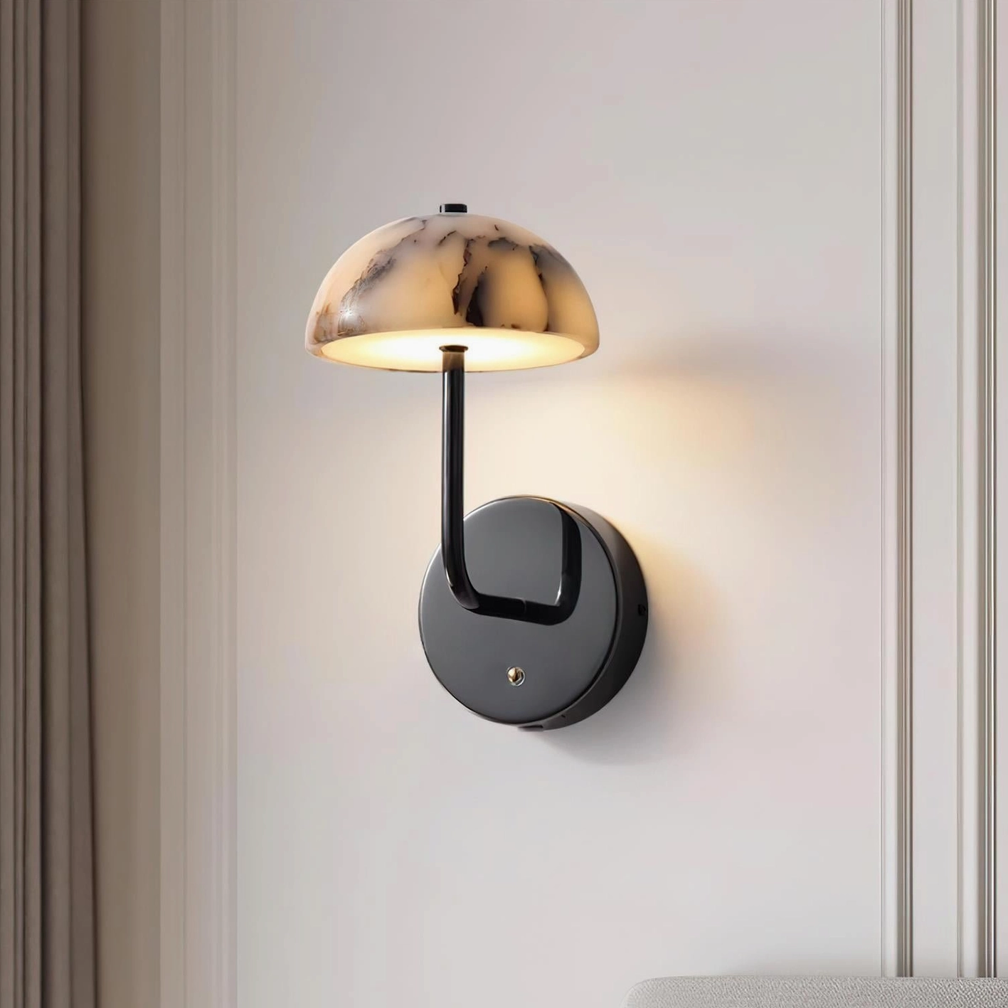 Penta modern wall lamp three-quarter angle showing black curved metal arm and marble dome on decorative molded wall