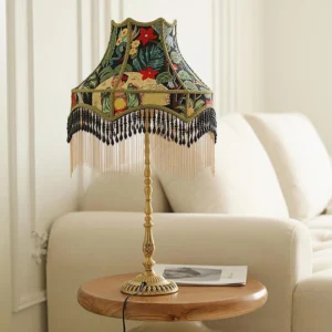 Retro peony botanical table lamp displayed on wooden side table beside beige sofa in minimalist living room