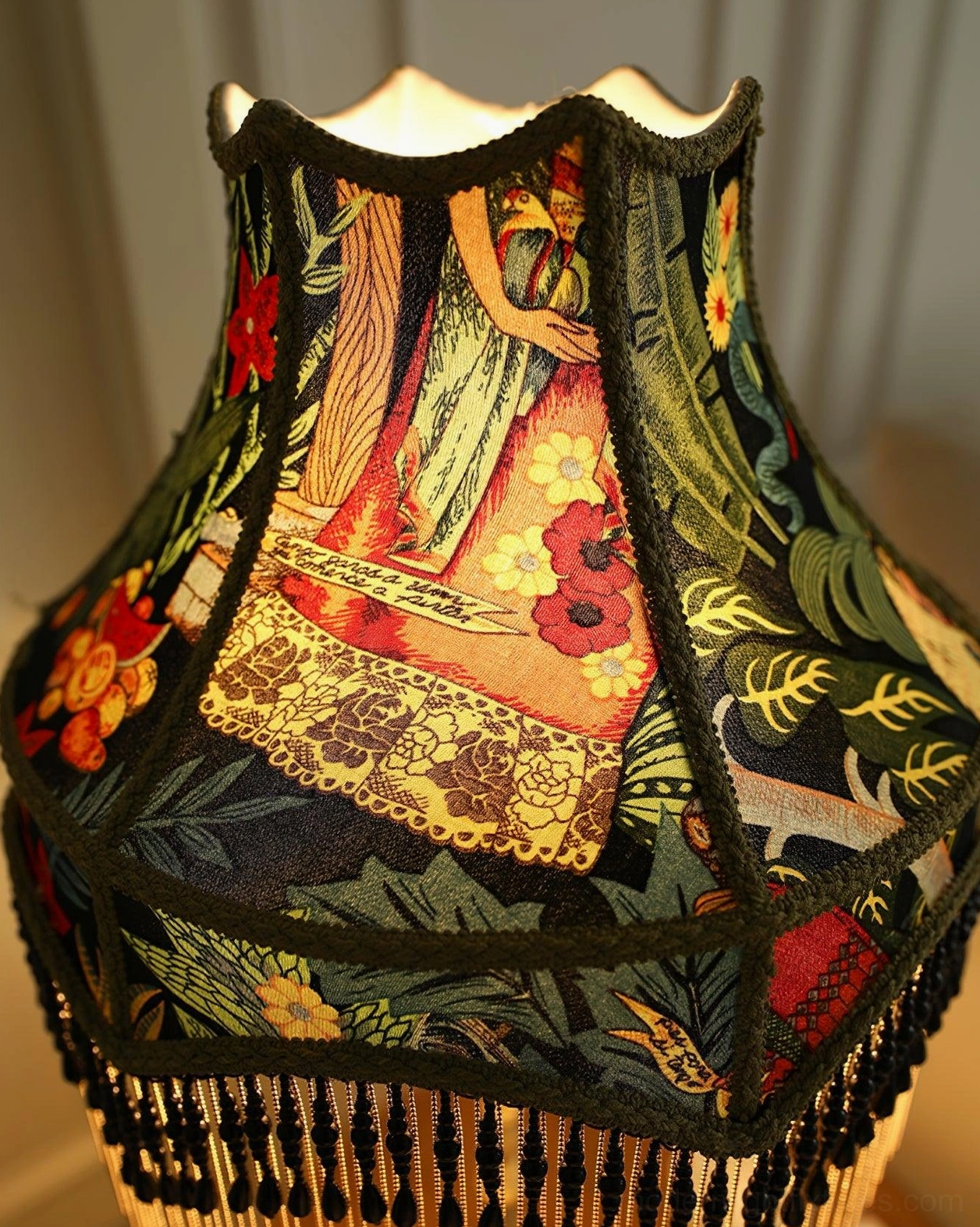 Three-quarter view of peony table lamp showing decorative fringe trim and brass base craftsmanship