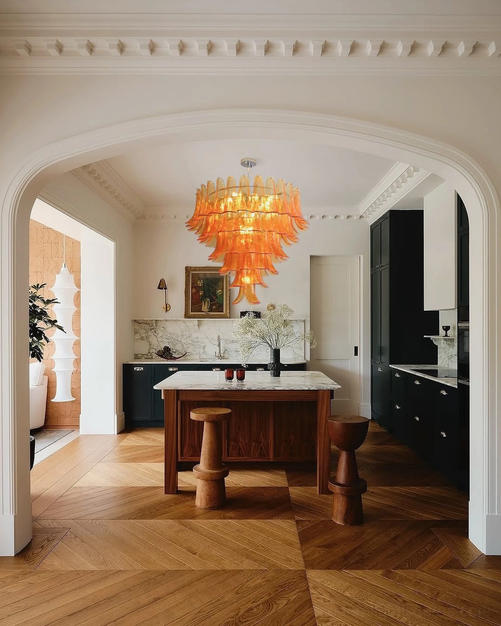 Hand-blown Murano glass petal chandelier creating dramatic shadows and light patterns on ceiling