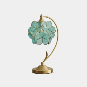 Petal glass table lamp with brass curved stand and turquoise blue flower-shaped shade, studio view