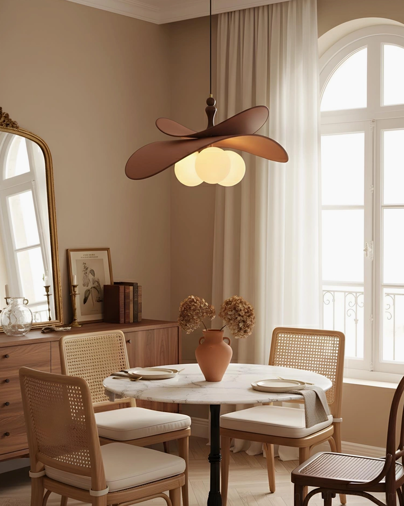 Petal pendant chandelier with brown fabric shades and warm globe lights hung in vintage dining room setting with arched window mid-century modern aesthetic