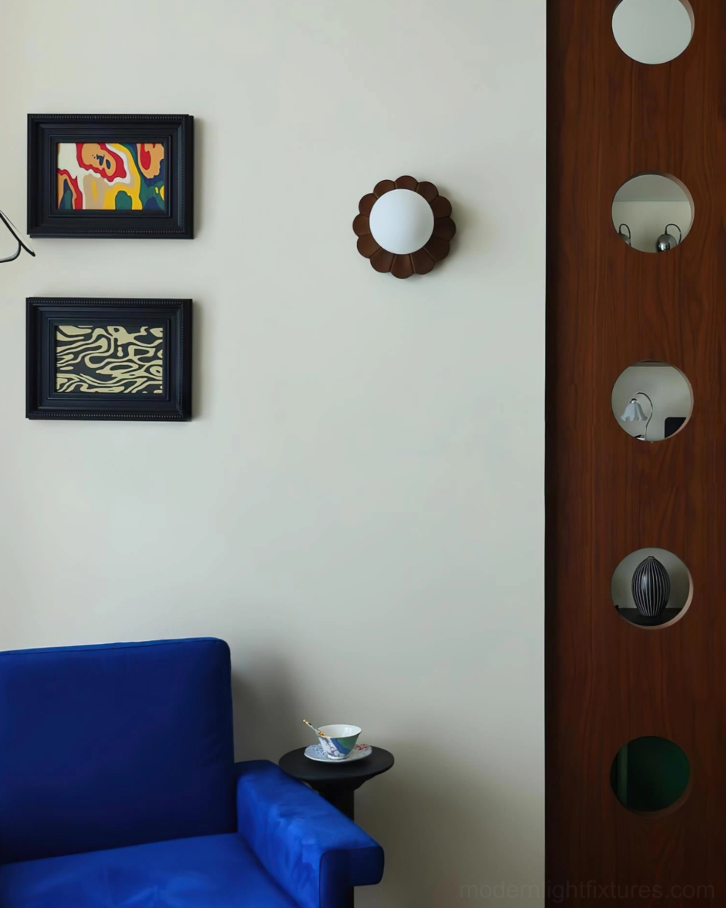 Wooden petal wall sconce illuminated in retro living space beside full-length mirror and wall art