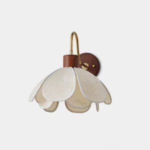 Petal wall sconce with embossed fabric shade and brass metal arm in modern minimalist design