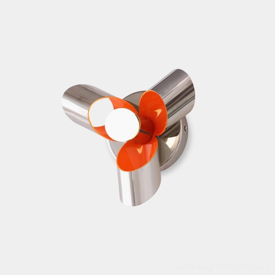 Petala chrome orange wall sconce with polished silver metal petals and warm orange interior accent, shown in three-quarter front overhead view against white studio backdrop