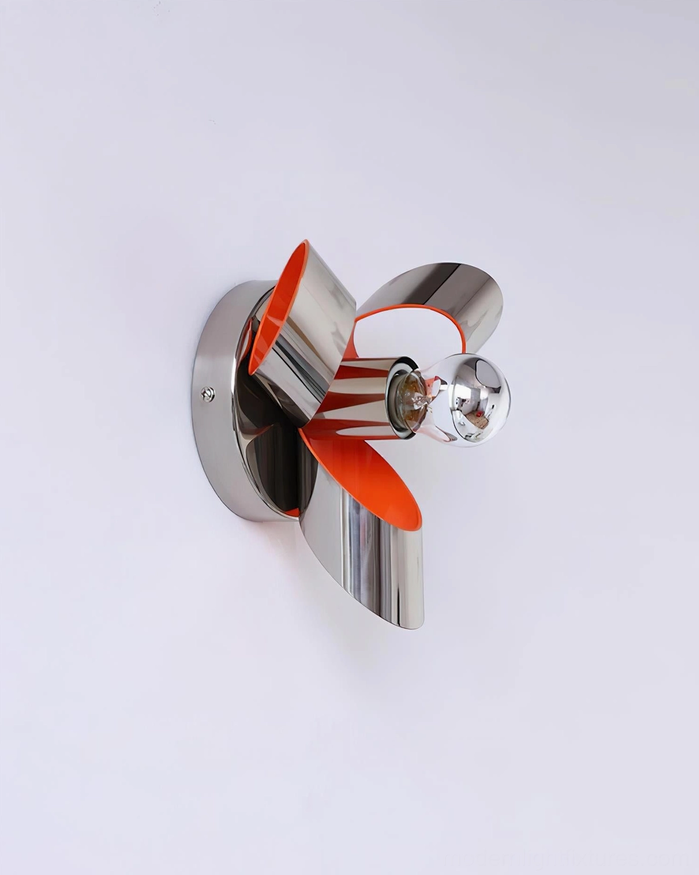 Petala chrome and orange wall sconce installed in contemporary bathroom setting, demonstrating damp-rated design and artistic lighting application