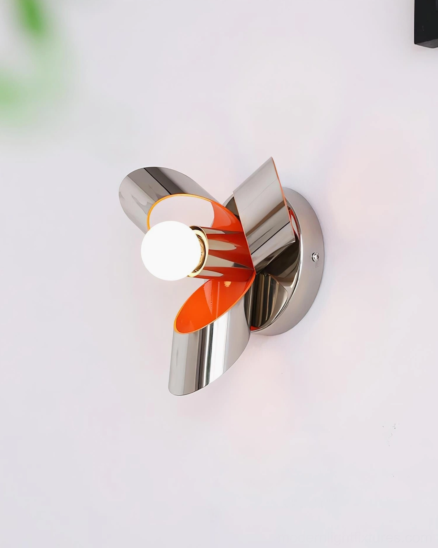 Petala modern wall sconce right three-quarter front view with exposed bulb, silver metallic body, and orange decorative petals on white background
