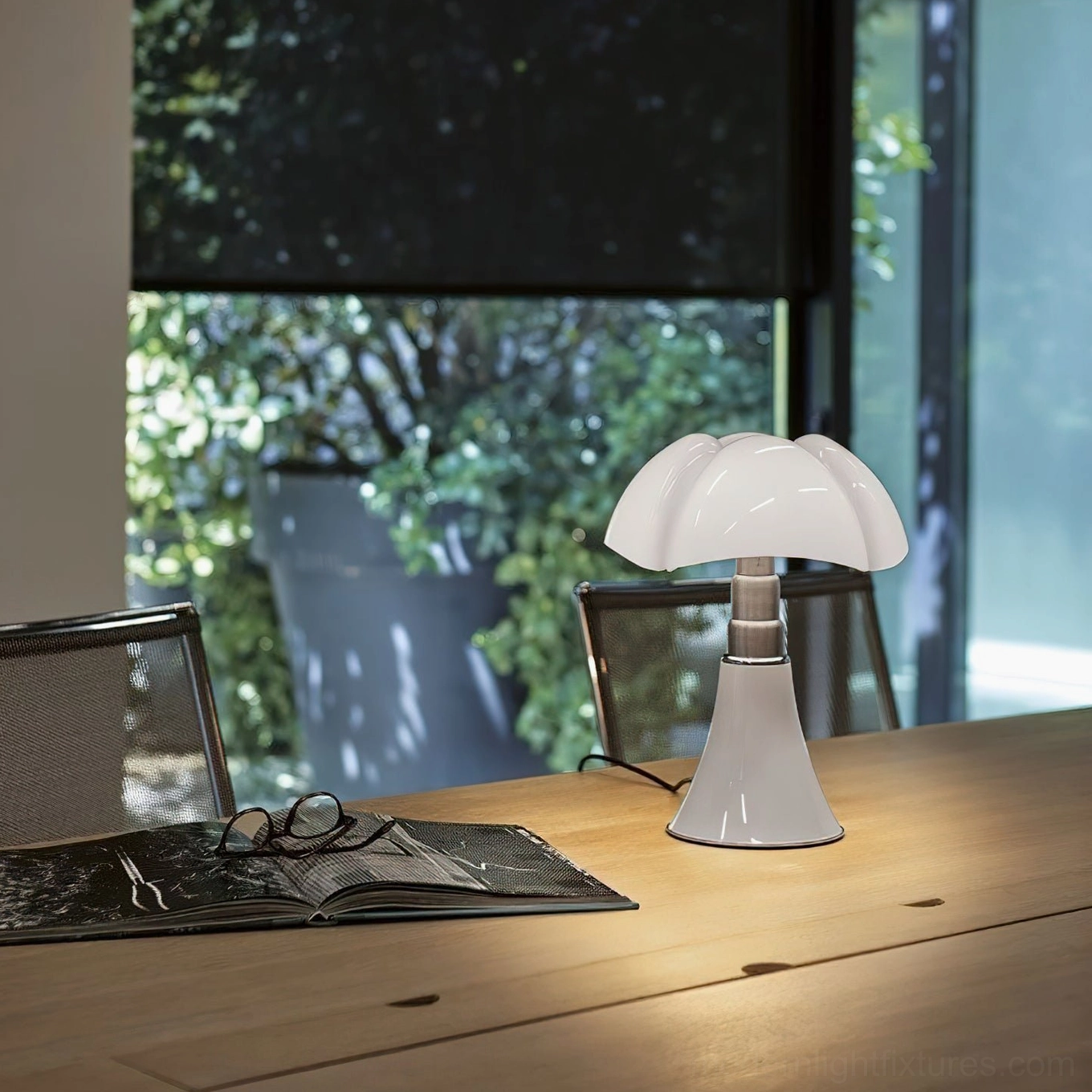 Petalica petal table lamp showing adjustable arm mechanism and rotatable shade for task lighting flexibility