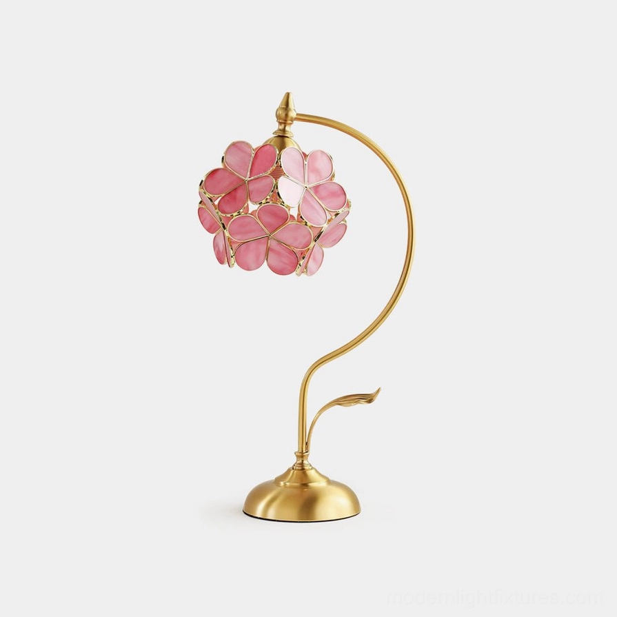 Petalora brass and stained glass table lamp front three-quarter view showing sculpted petal shade design on white background