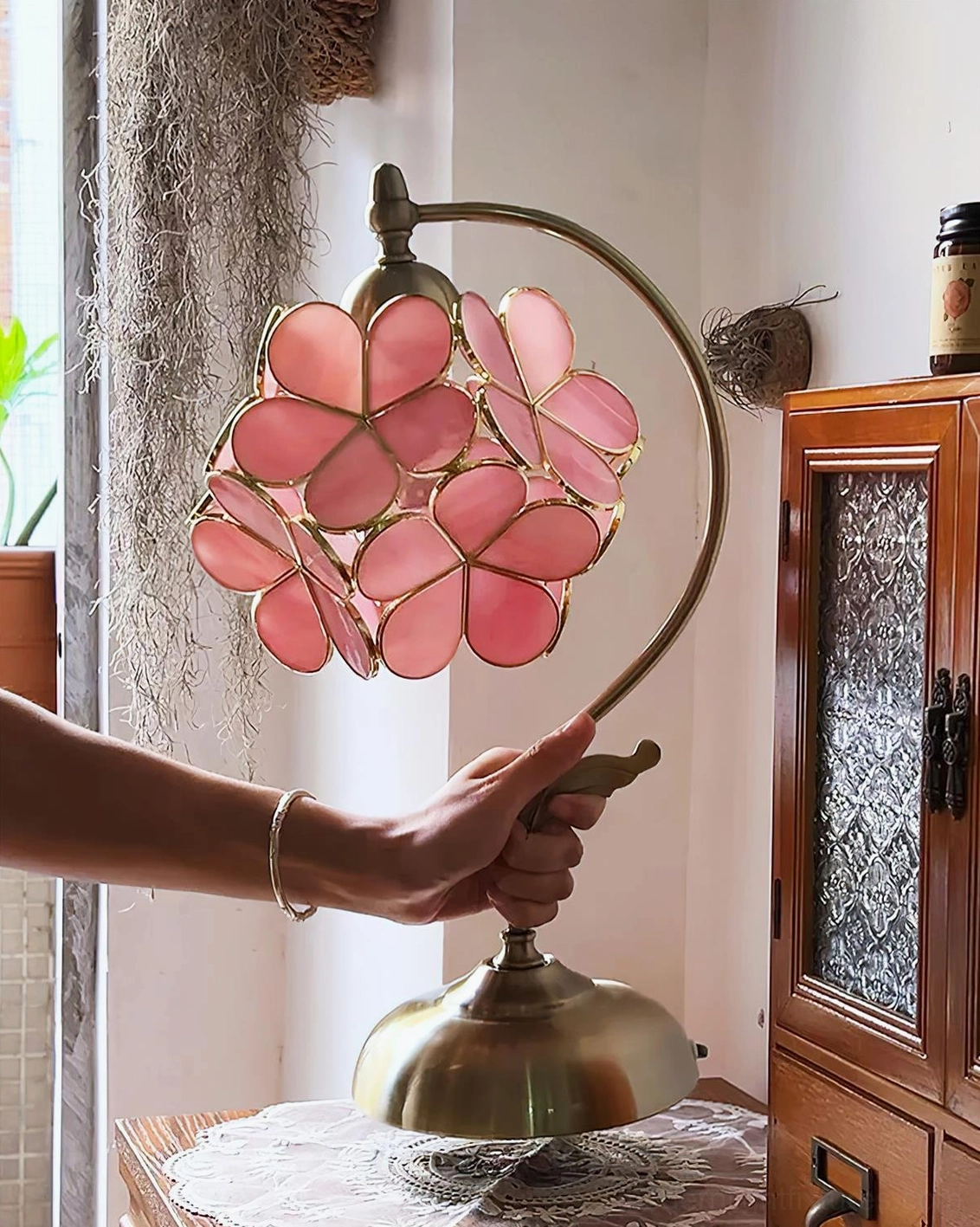 Petalora table lamp close-up side view of brass stem and detailed petal glass shade in vintage home entryway