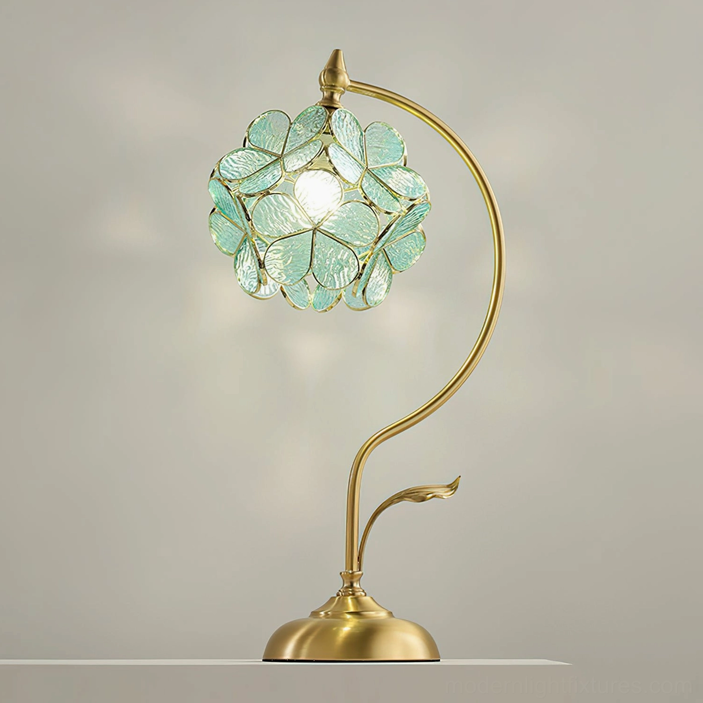 Green Petalora stained glass petal table lamp with brass detailing showing jewel tone color option