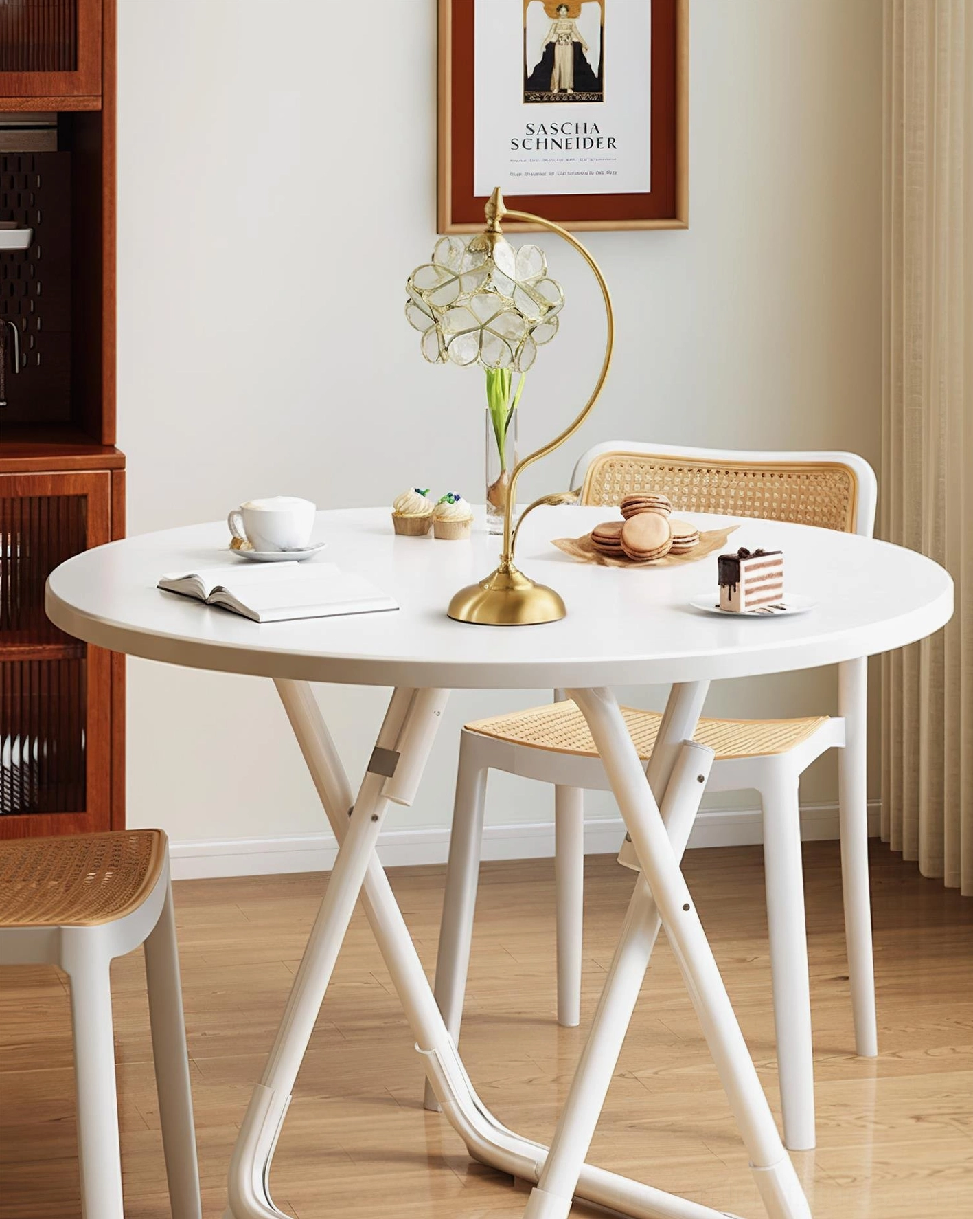 Petalora brass table lamp on white round dining table with place settings in small apartment dining area