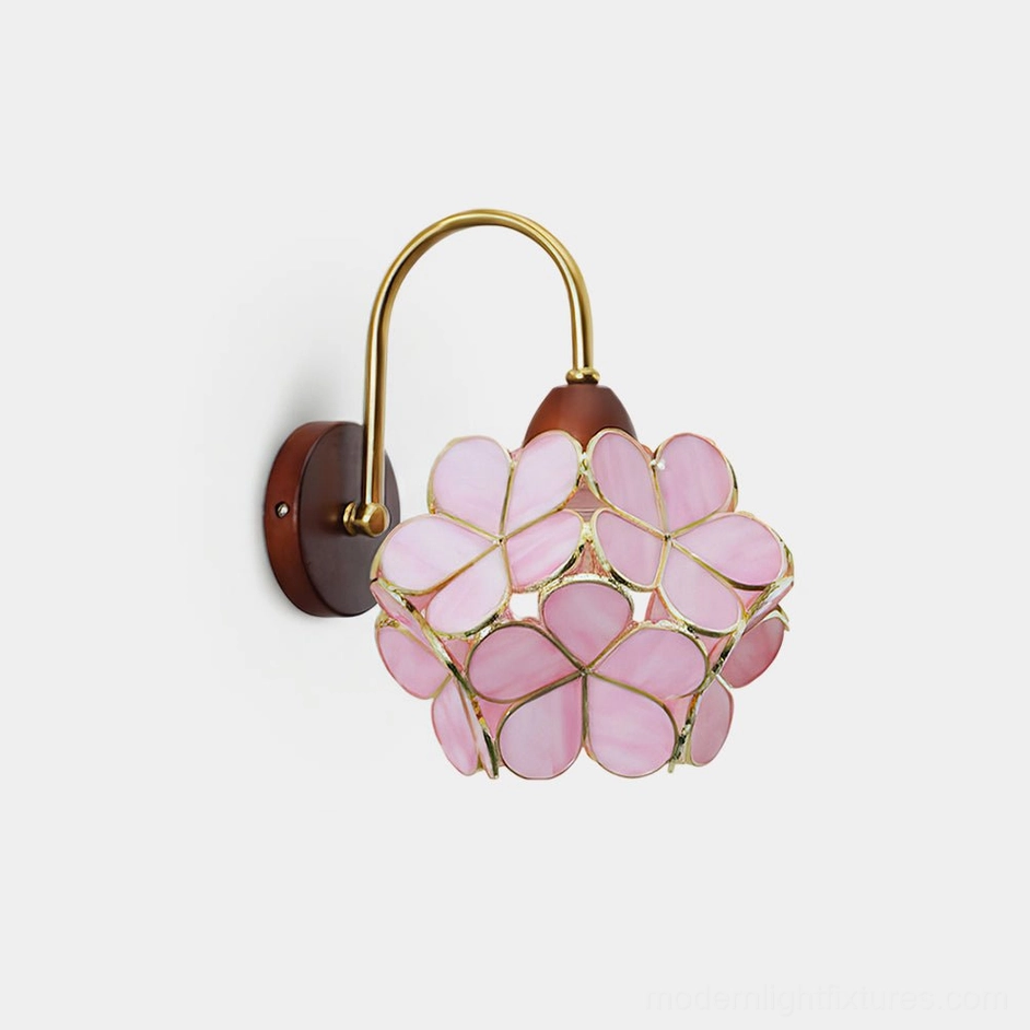 Petalora floral wall sconce with pink stained glass petals and brass frame, front studio view on white background