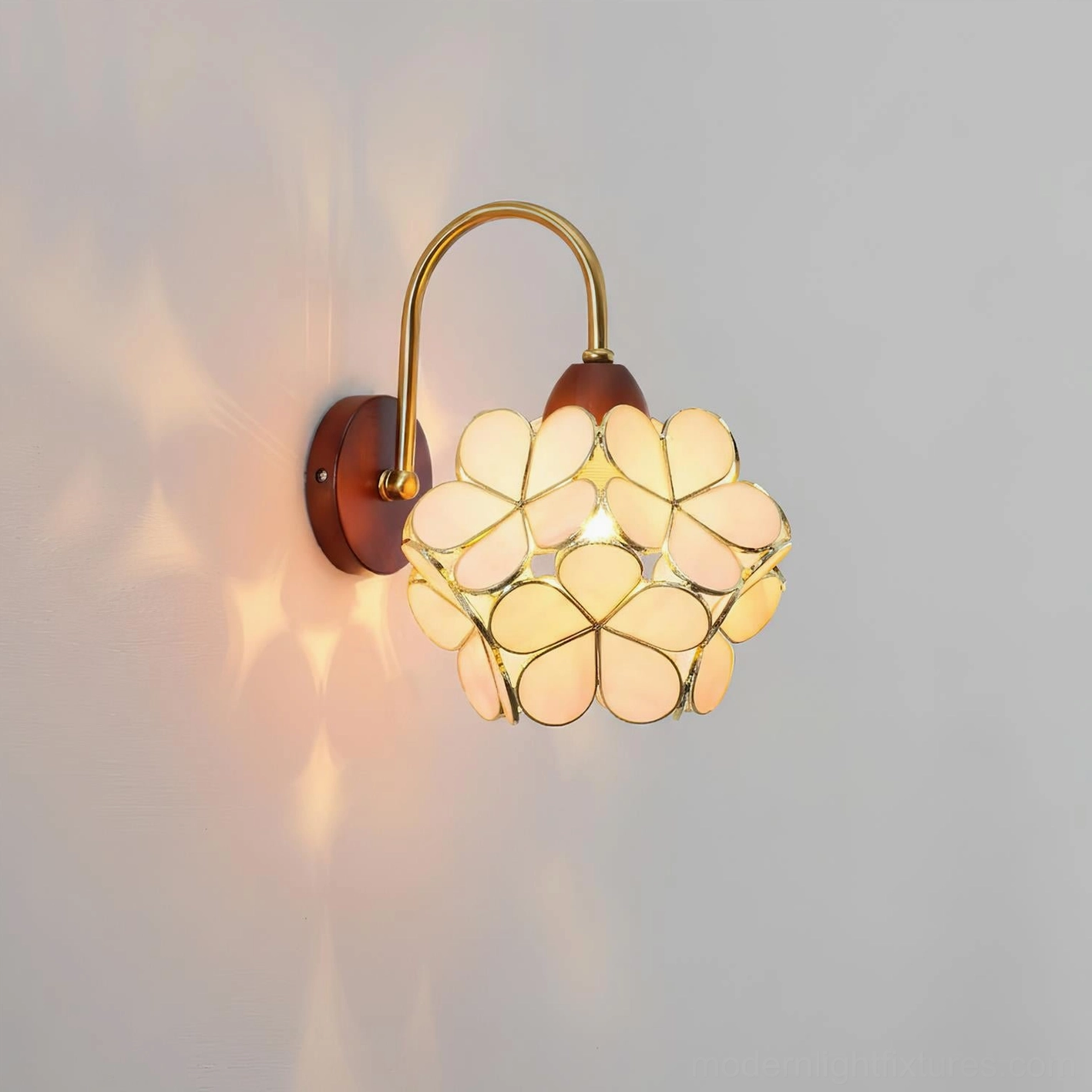Petalora cream floral wall sconce installed on accent wall casting decorative petal light shadows