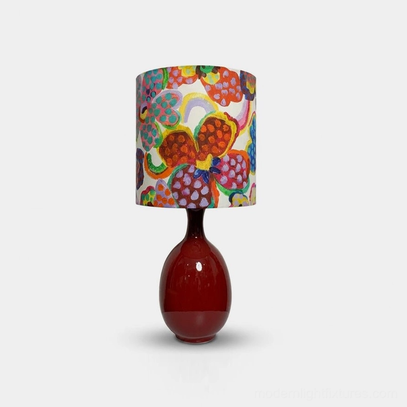 Petalyn ceramic table lamp with hand-glazed oxblood red base and printed floral fabric drum shade, front studio view