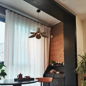 Petanova wood pendant lamp installed in residential dining room with sheer curtains warm home decor