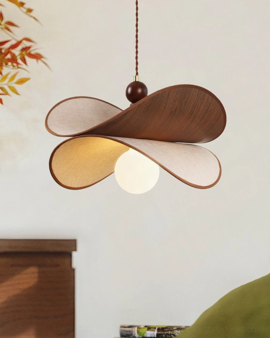 Petavin sculptural pendant light detail showing walnut wood petal grain and cream linen fabric, oblique angle with brass cord