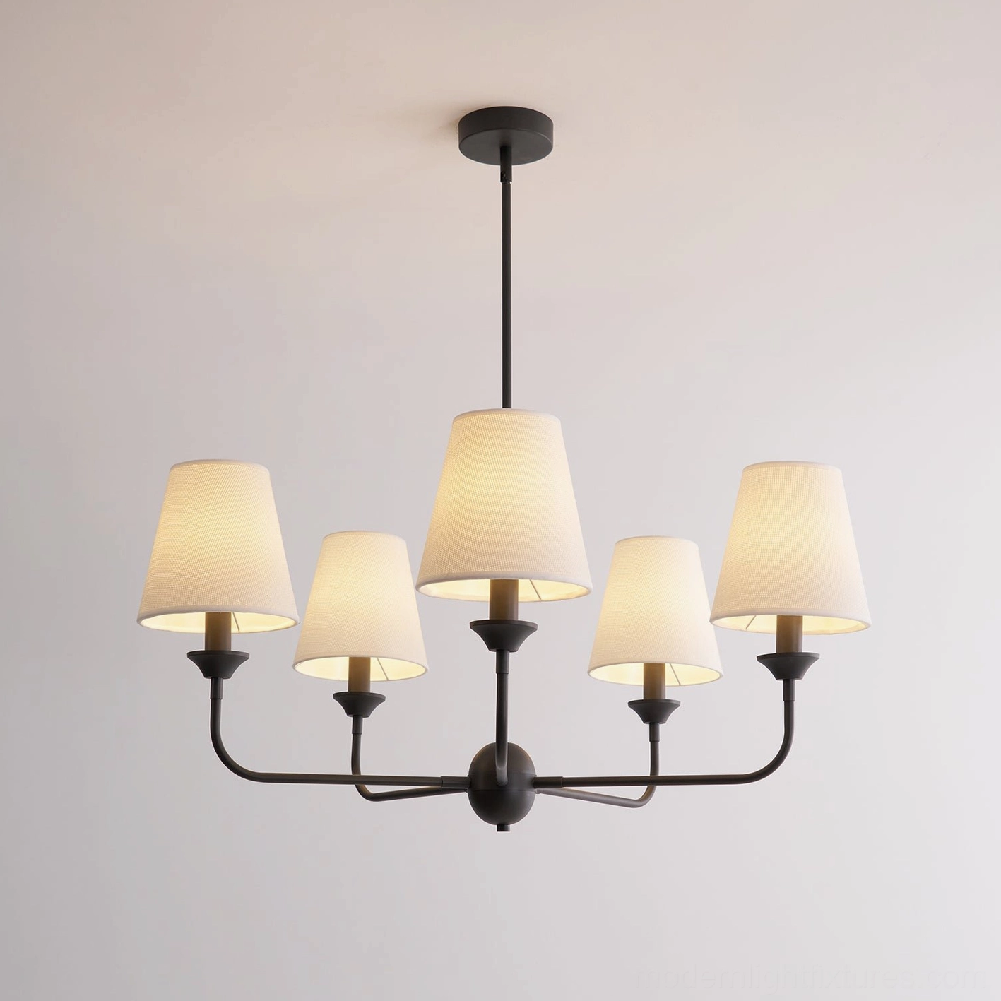 Piaf large chandelier illuminated showing warm white light diffusion through fabric shades