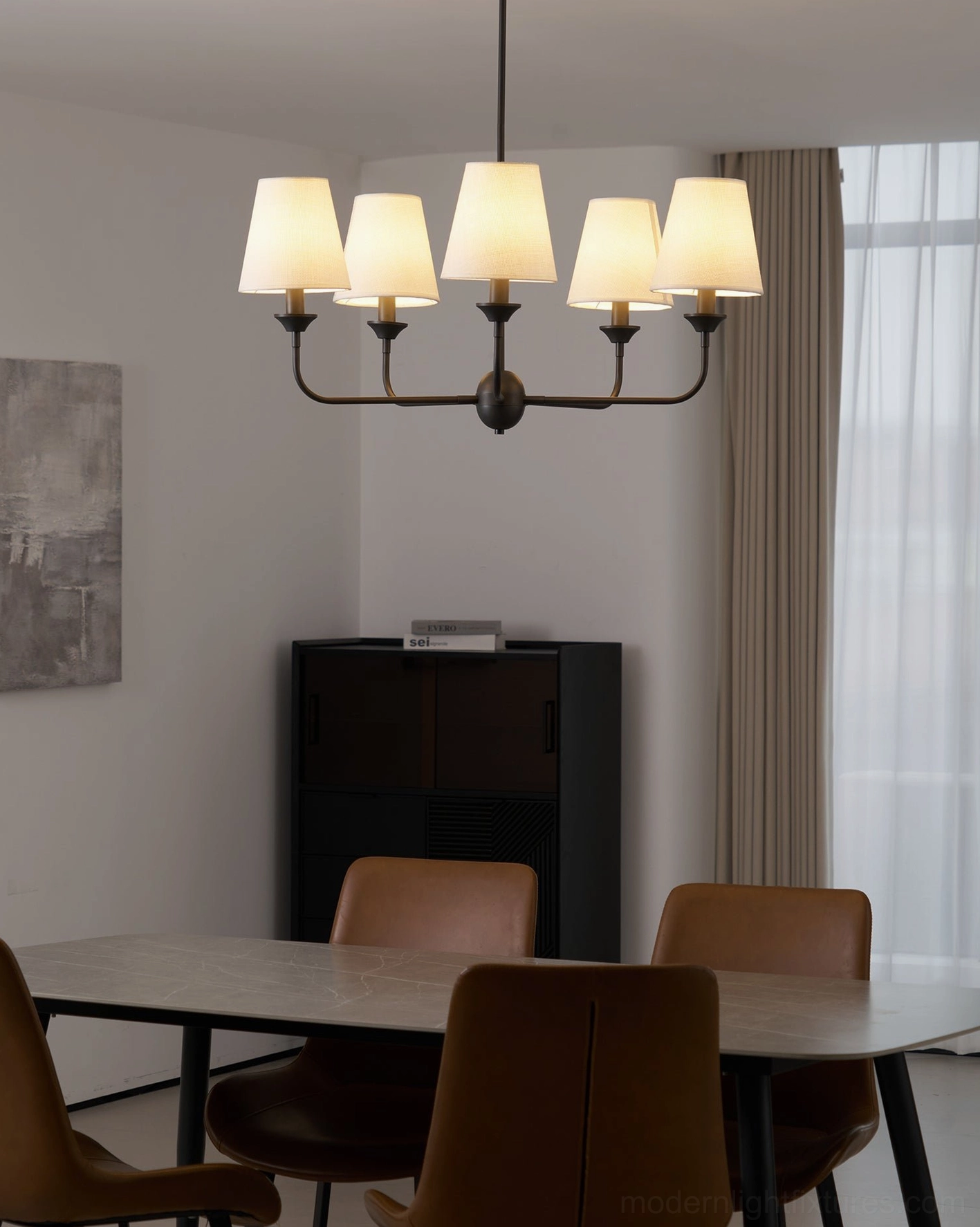 Piaf 5-arm chandelier side view in minimalist dining room with warm neutral interior design