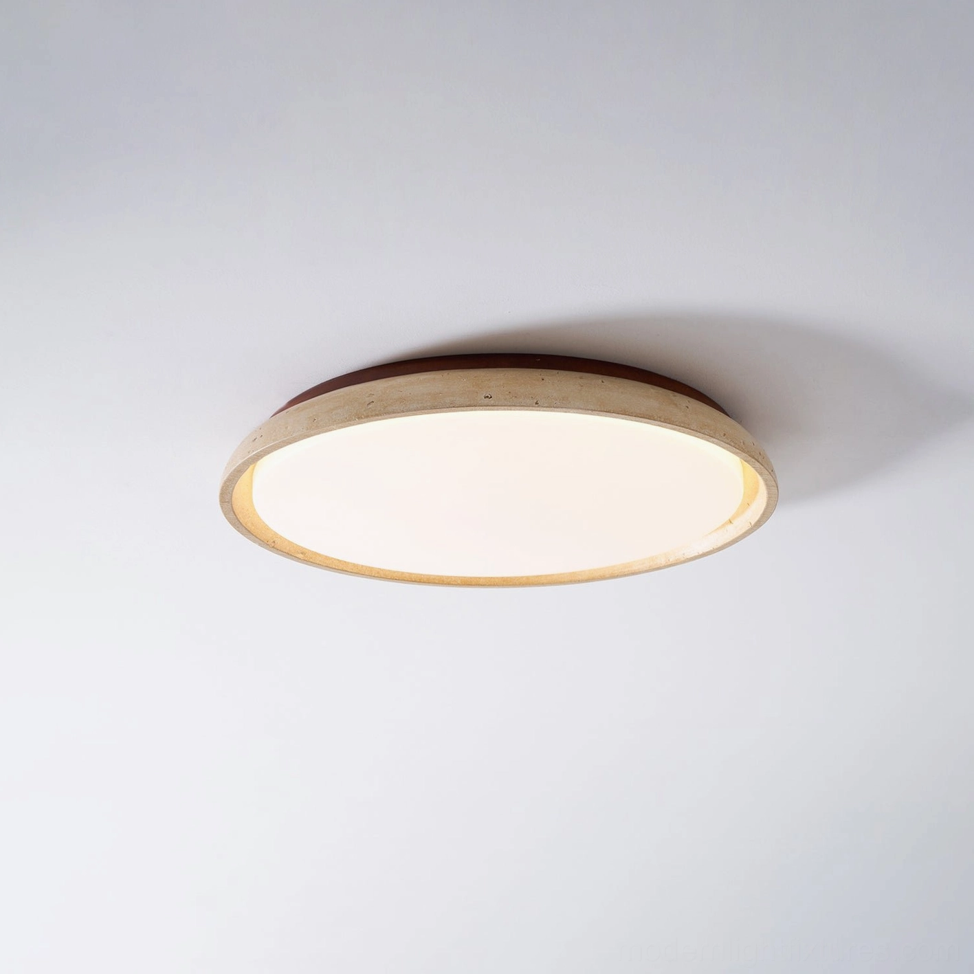 Piedra travertine ceiling light creating warm ambient lighting in luxury interior space