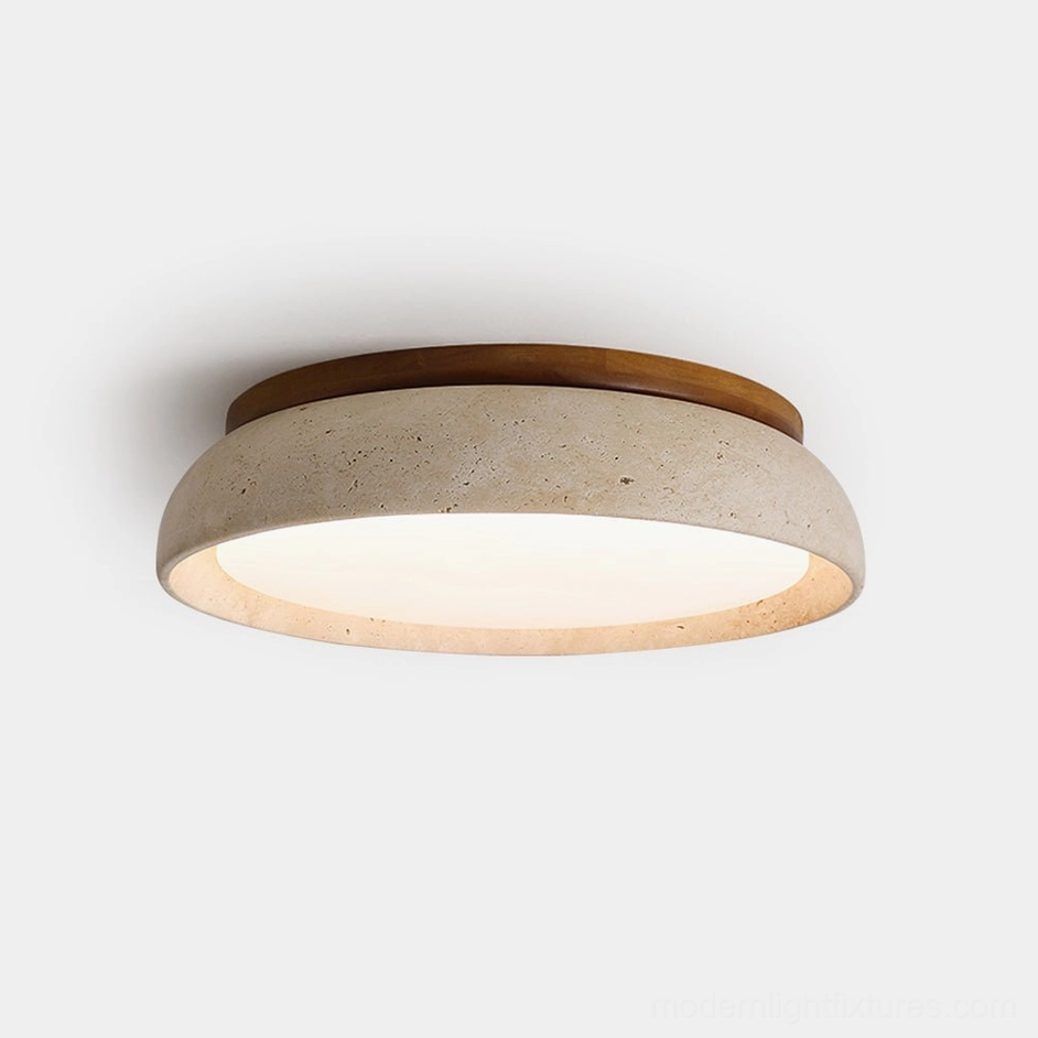 Piedra natural travertine ceiling light, front close-up view showing warm wood ring and porous stone texture on white background