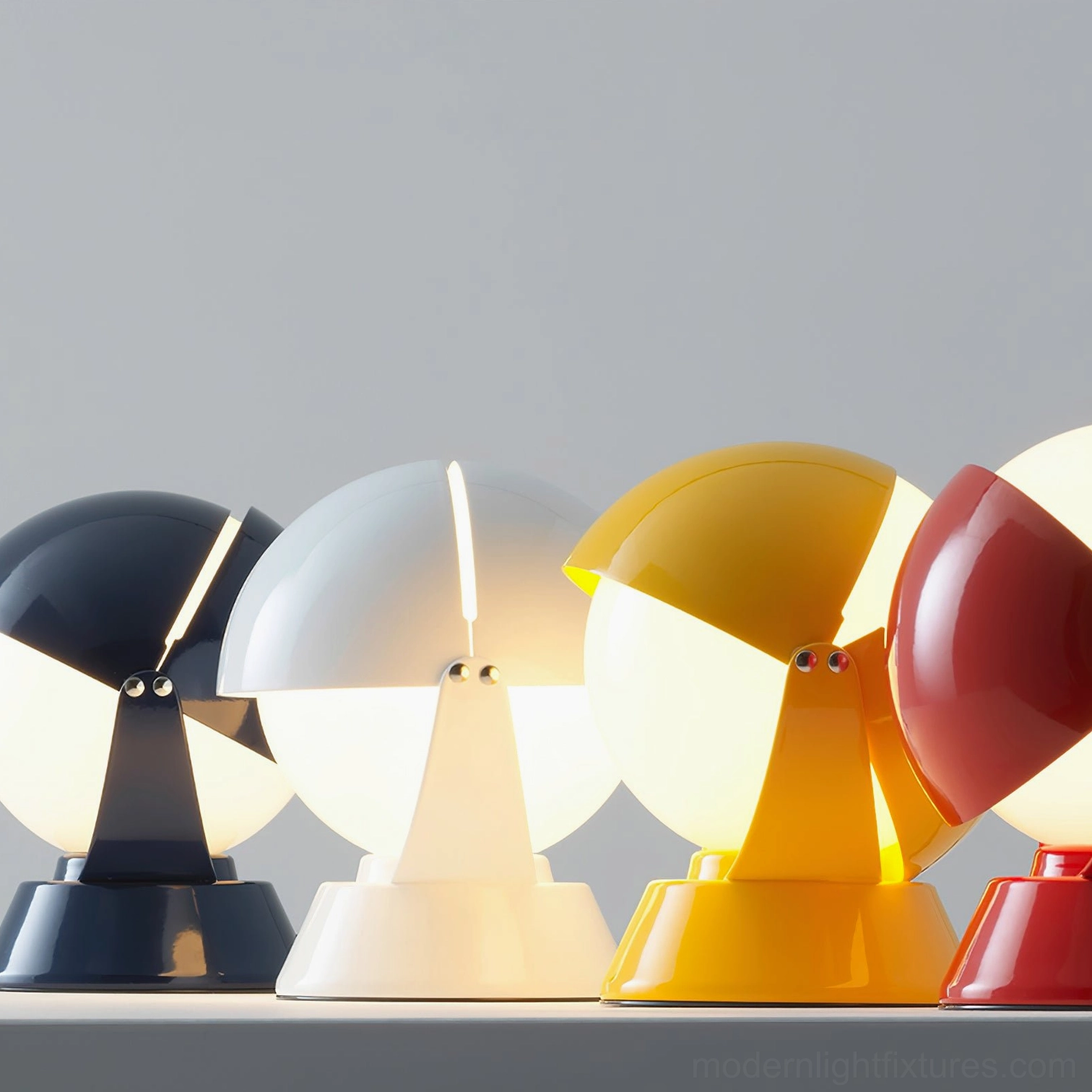 Low-angle front view of four illuminated Pileino table lamps in assorted colors - red, yellow, blue, white