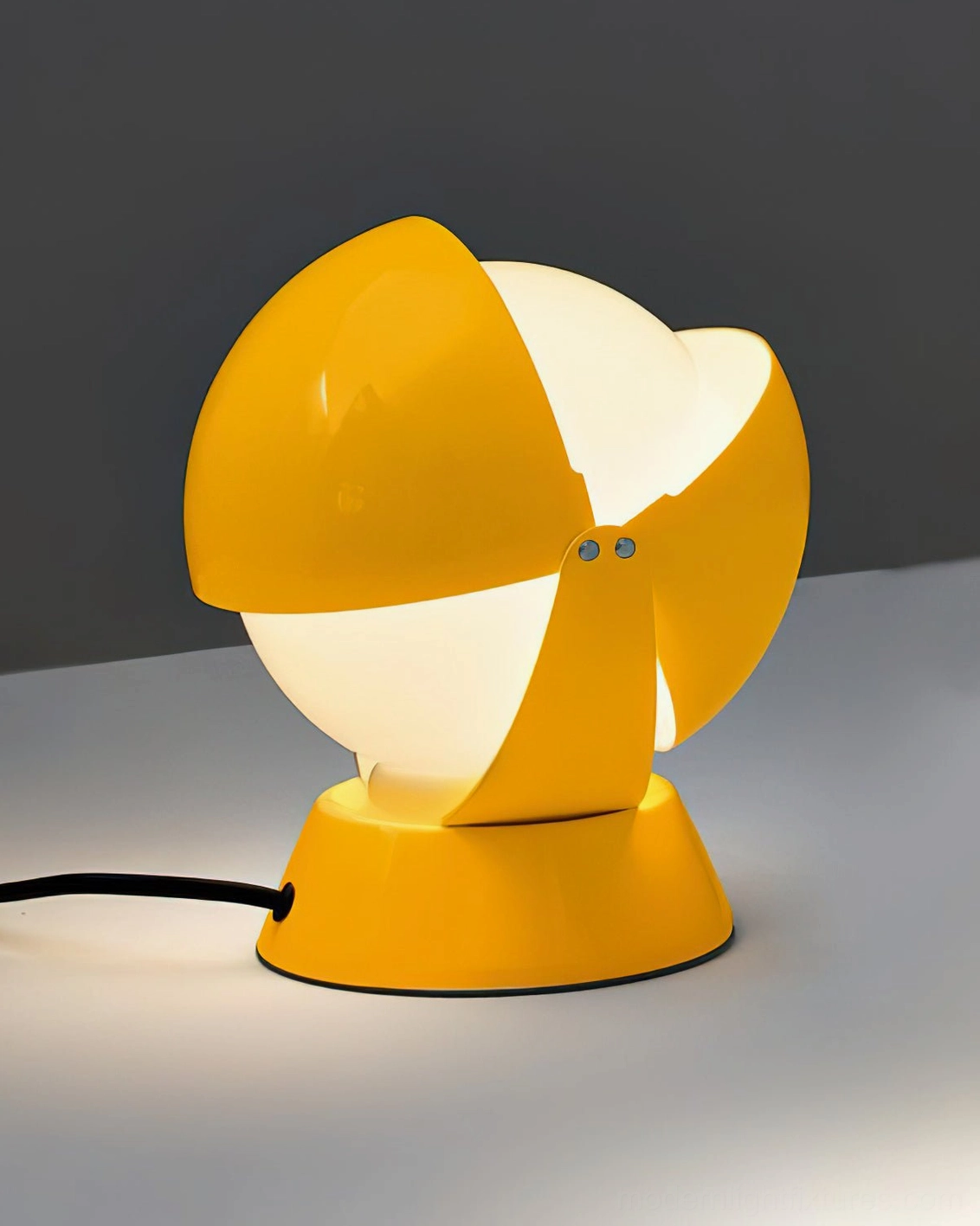 Minimalist workspace with Pileino modern table lamp providing focused task lighting on desk