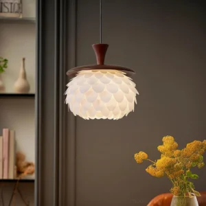 Modern pinecone pendant light hanging above dining table in warm home interior - demonstrating soft ambient lighting in dining room setting
