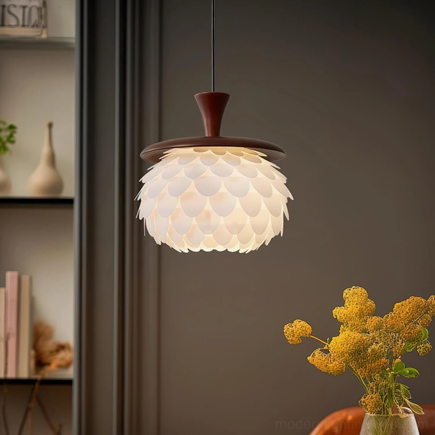 Modern pinecone pendant light hanging above dining table in warm home interior - demonstrating soft ambient lighting in dining room setting