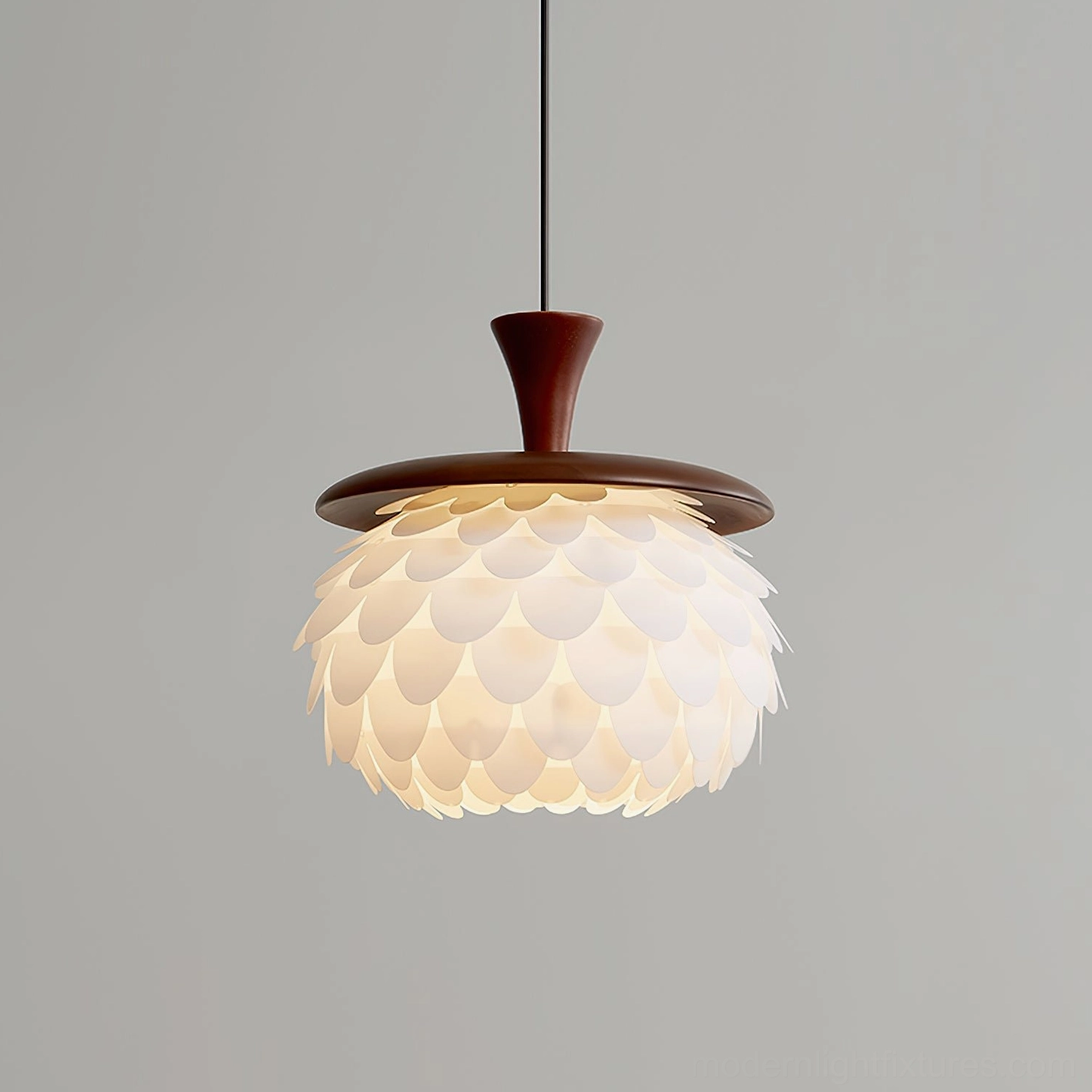 Pinecone petal pendant light fixture front view against grey wall - showing walnut wood top and soft glowing white translucent shade