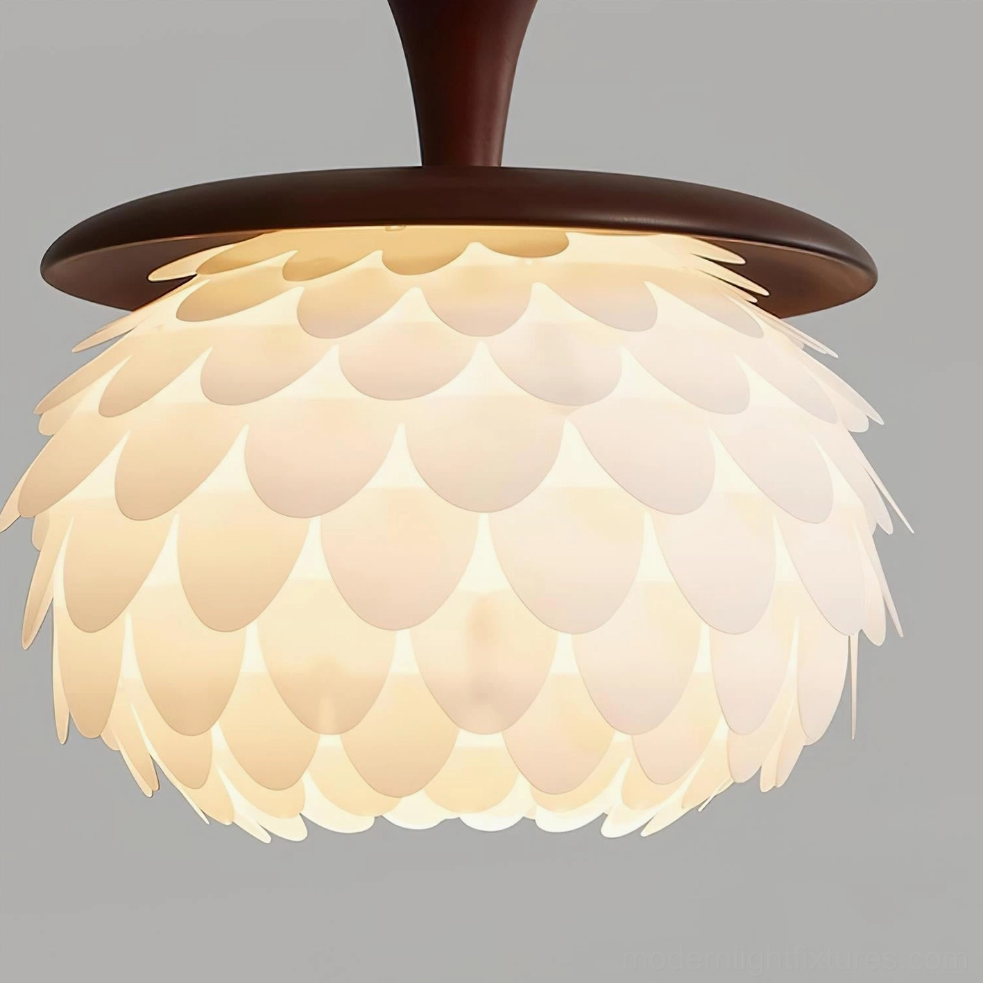 Pinecone pendant fixture showcasing translucent acrylic layers filtering warm 3000K LED light in sophisticated interior design setting
