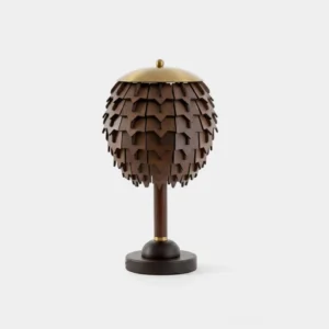 Handcrafted pinecone wooden table lamp with brass crown on white background, displaying intricate layered wood scales design