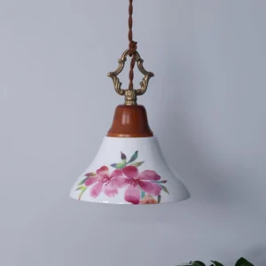 Pink floral ceramic pendant lamp, three-quarter side angle showing conical shade shape and painted azalea design