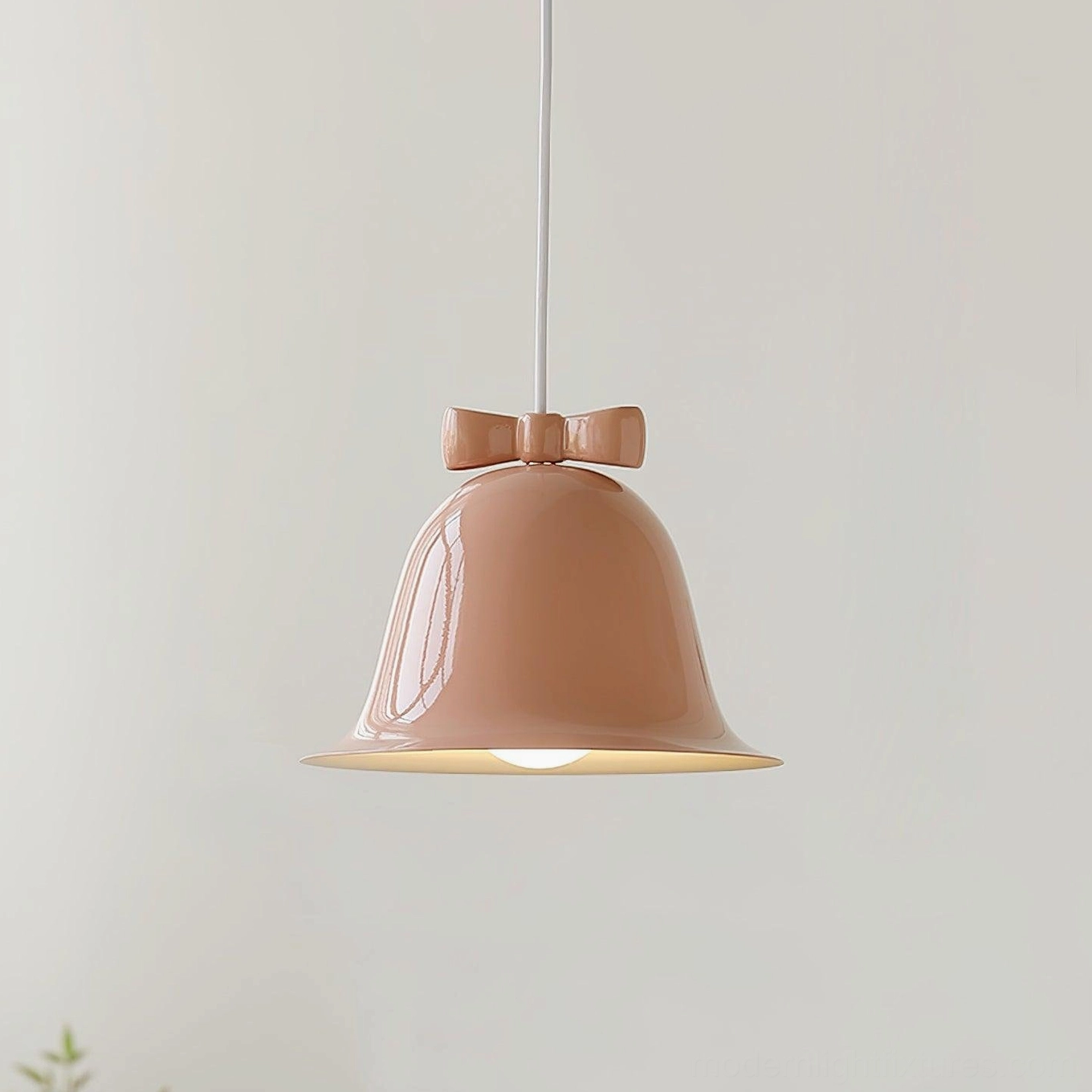 Pink ceramic bell-shaped pendant lamp with decorative bow detail on white background