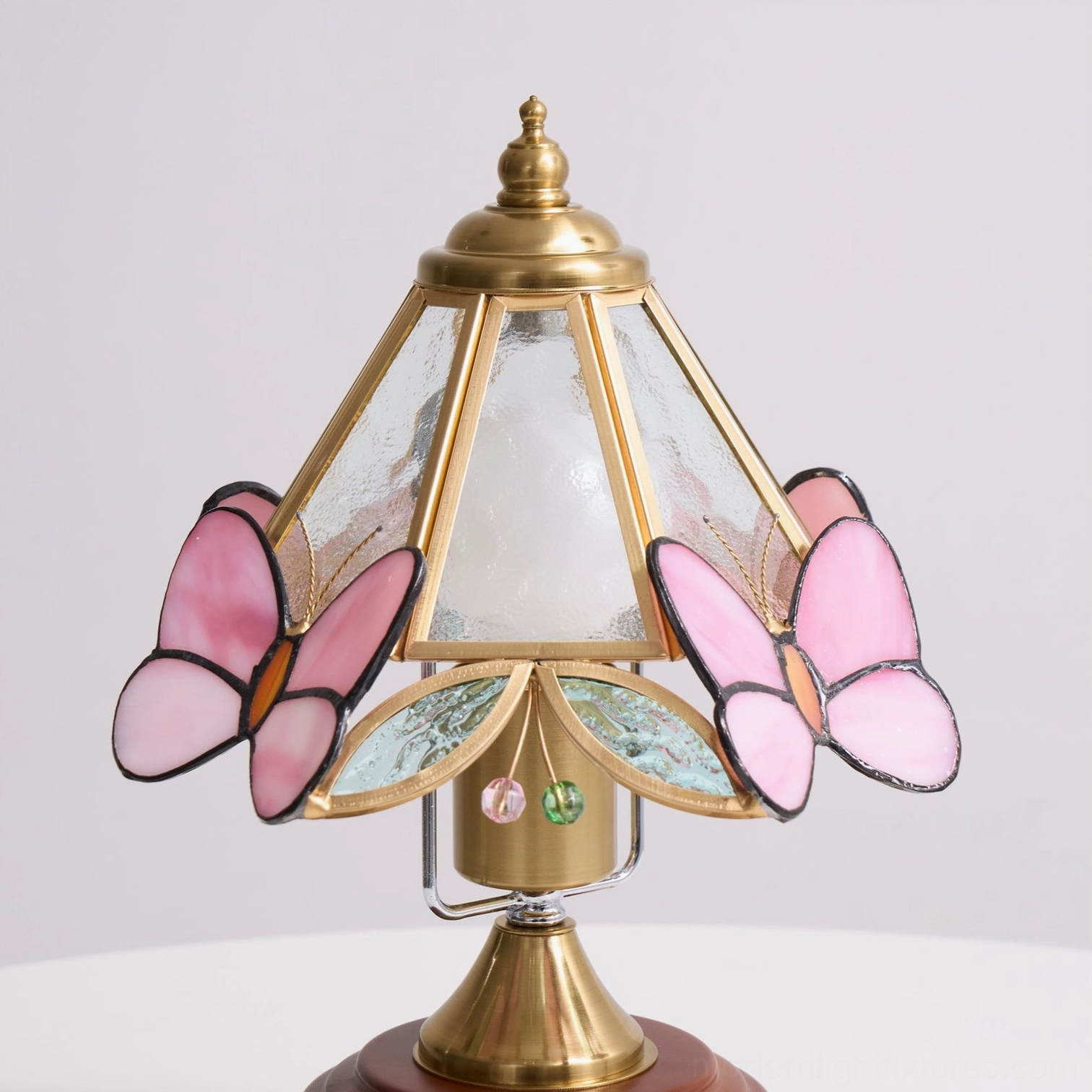 Pink butterfly Tiffany-style table lamp color and finish showcase in living room decor context