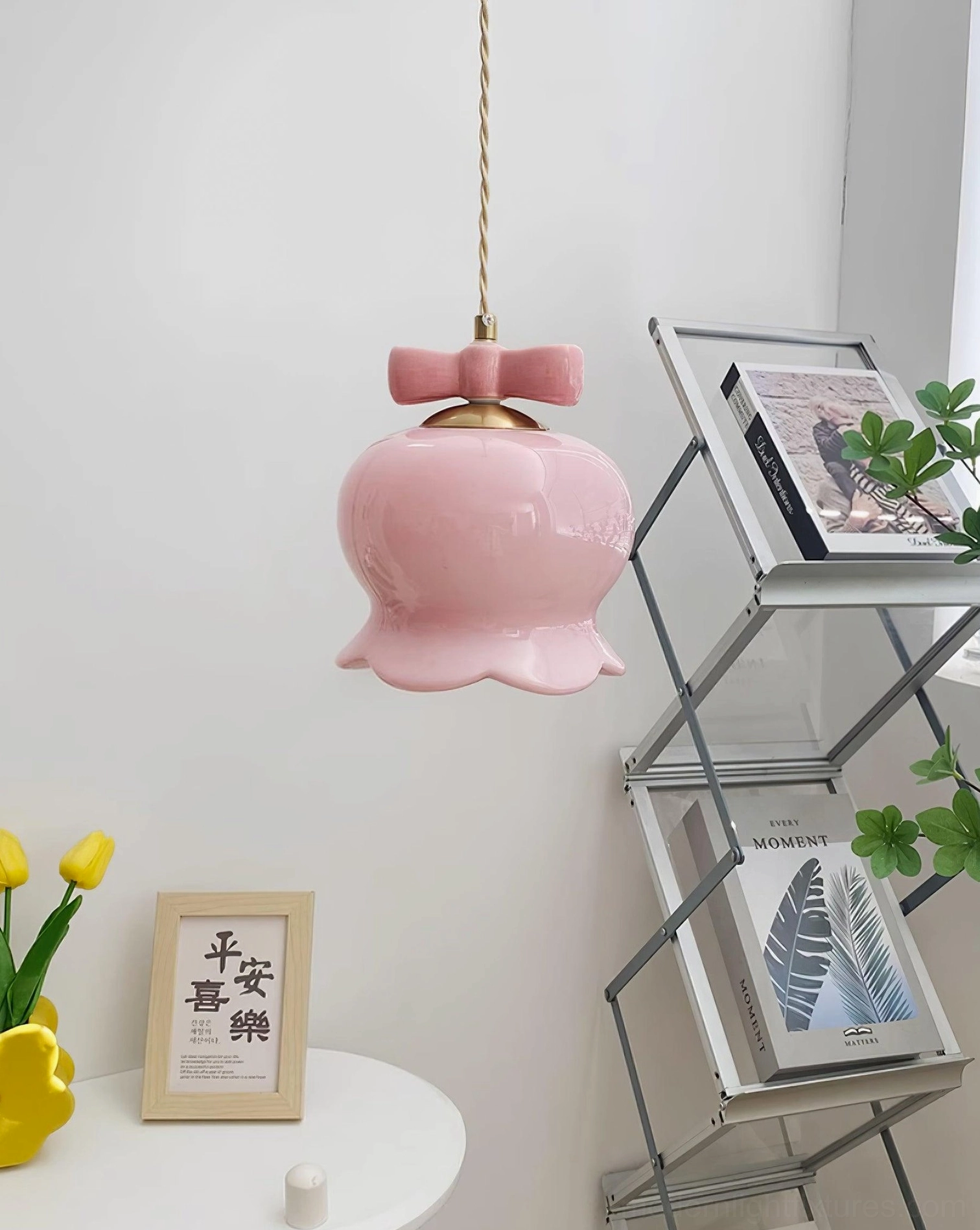 Pink ceramic bellflower pendant light with braided cord hanging in home study corner
