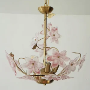 Pink floral glass chandelier with curved brass branches and delicate petal arrangements, three-quarter side angle