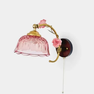 Pink Roseraie Verse floral wall sconce with brass metal arm and carved glass shade in studio lighting