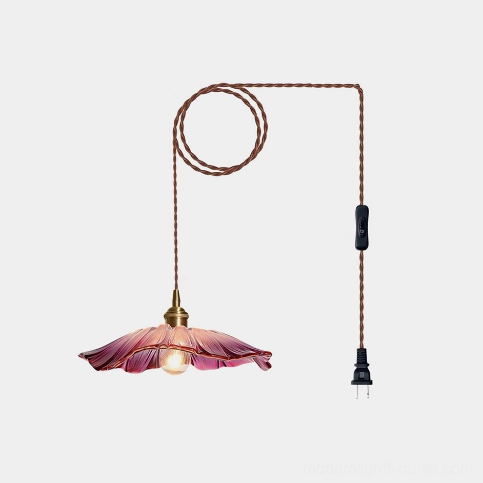 Flower glass plug-in pendant light with pink petal shade and twisted brown cord, front view against white background