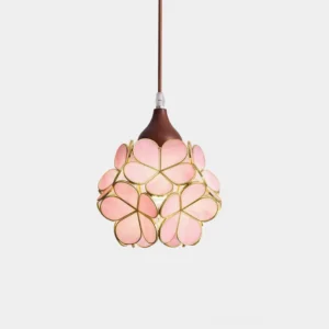 Pink stained glass flower pendant light with gold metal trim, close-up studio shot showcasing botanical petal design and light wood grain ceiling cap