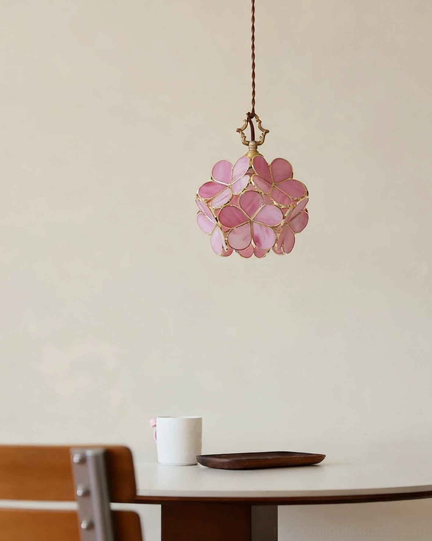Pink stained glass floral pendant fixture with brass hardware in minimalist home corner