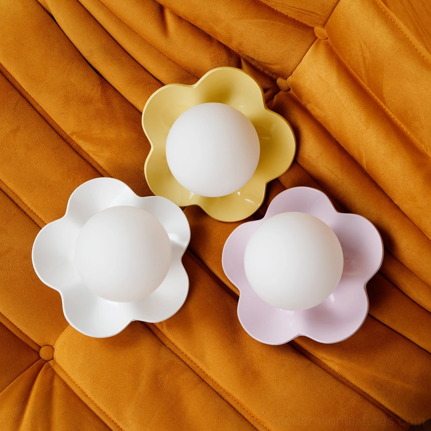 Pink flower wall sconce as statement lighting piece in boutique home design gallery wall